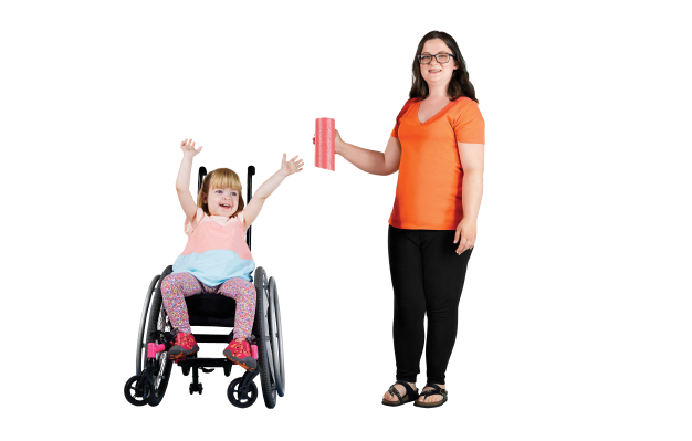 A child with light skin tone and blonde hair using a wheelchair. She is wearing a pink shirt and is waving her arms in the air. She is next to her mother, who has light skin tone and brown hair. She is wearing an orange shirt and black pants.