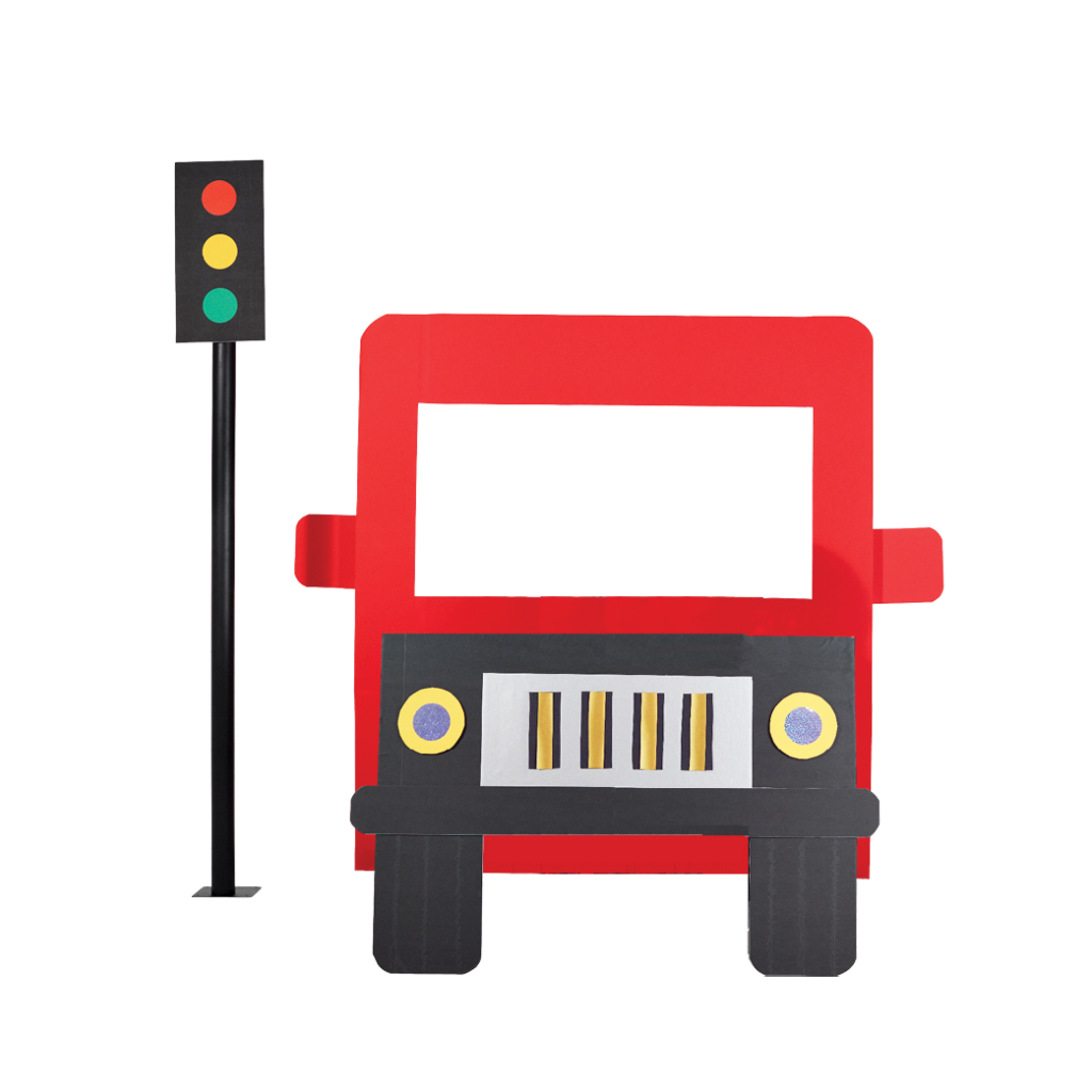 A black and red bus stopped beside a traffic light. The traffic light has red, yellow and green lights.